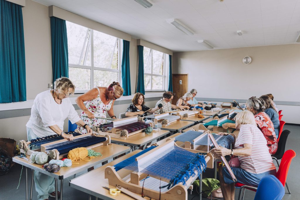 A group of workshop participants try weaving inspired by stories of Hull's floods